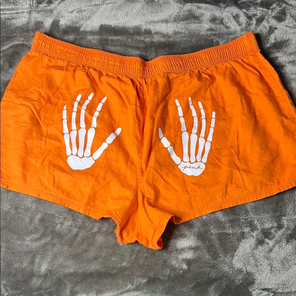 Orange Shorts with Skeleton Hand Design